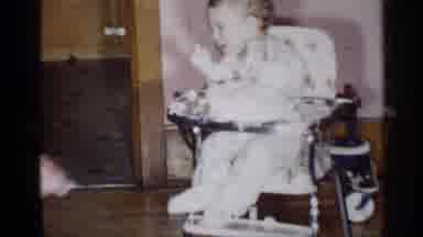 New York (1955): Woman Wearing Blue Dress Retrieves Small White Object Father Baby