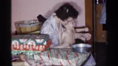 New York (1955): Mom Washing Her Baby In Tub But Baby Is Varying