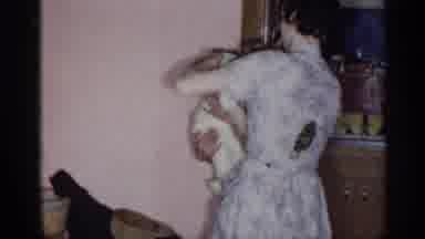 New York (1955): Baby Getting Dressed By Adult A Running To Man Sitting In Chair