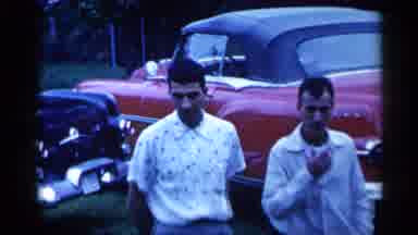 New York (1955): Man Smokes Cigarette While Walking Next To ANOther Man Child In