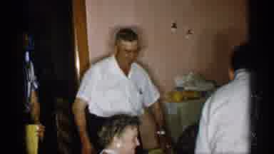 New York (1955): Man Wearing White Shirt And Glasses Sits Down At Dinner Table