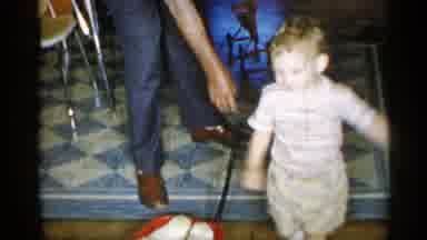 New York (1955): Man On Telephone Watches Toddler Walk A Run To Climb On Couch