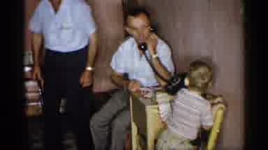 New York (1955): Child Playing A Kneeling On Chair S Man Picks Up Phone