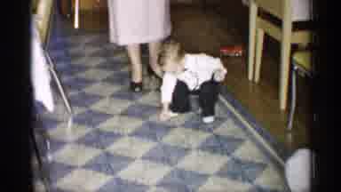 New York (1955): Multiple Generations Watch Toddler Drop Ball On Living Room Flo