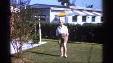 Alabama (1958): Woman In White Shirt And Khaki Brown Shooter Becks Up In Yard And