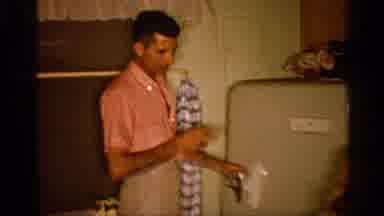Alabama (1958): Man Wearing Pink Shirt Opens Weatherstripping Do Other While Boy
