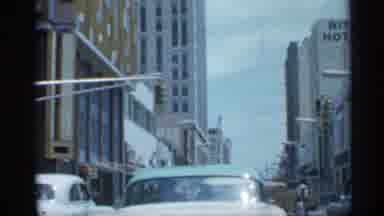 Florida (1958): Vehicle Travels Down City Street Past Ritz Hotel And Moo Station