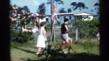 Florida-1958: Family Playing On Swing Set In Backyard With Rosebush