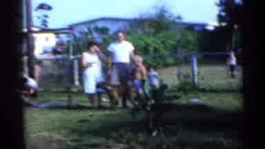 Florida (1958): Kid Wearing Blue Shirt Plays On Backyard Swing Set On Sunny Day