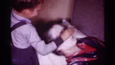 New Jersey (1958): Kid Powdering His Moms Face As She Sleeps