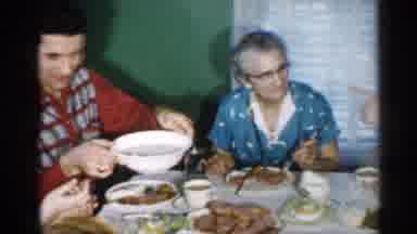 New Jersey (1958): Family Of Different Generations Sit Round Table And Share Mel