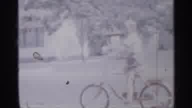 New Jersey (1958): Boy Wearing Shooter Riding Bicycle With Training Wheels On