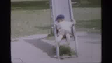 New Jersey (1958): Child In Shooter Shirt And Ht Slides Backwards Down Slide In