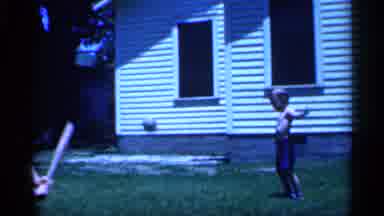 New Jersey (1958): Two Young Boys With Baseball Ts The Swings At Baseball In Yard