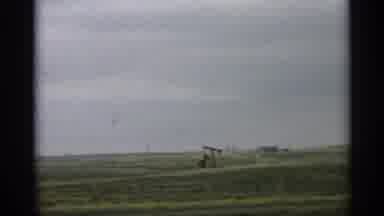 Arizona (1959): Oil Well In Green Field On Cloudy Day