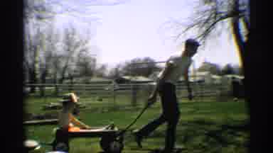 Arizona (1959): Man Carries Two Children On Wheelbarrows While Third Walks On