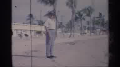 California (1959): Well Dressed Man Eves To Tourist Enjoying Sun And Wind One
