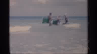 California (1959): People Standing In Ocean Holding Floating Devices In Eves While