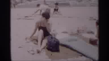 California (1959): Woman Sitting On Towel On Sandy Beach Lens Over And Mys