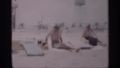 California (1959): Man And Women Sitting On Sn At Beach During Day