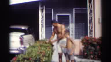 California (1959): Man And His Son Taking Flowers Father On Garden Of House