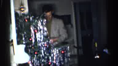 California (1959): Man Over Decorated Tinsel Christmas Tree With Presents Nelly