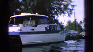 California (1959): Boats Docked In River Surrounded By Palm Trees With Supercity