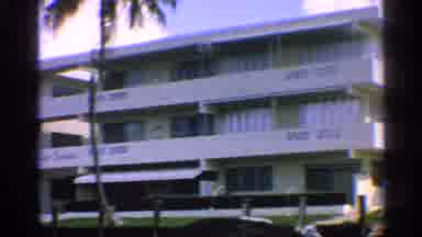 California-1959: Vintage 8mm Footage of a Mid-Century Apartment Building with Palm Trees and Water Views