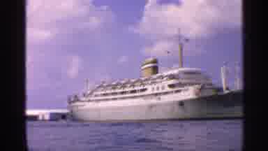 California (1959): Possible Cruise Ship Sits In Ar Bother At Dock Under Blue Sky