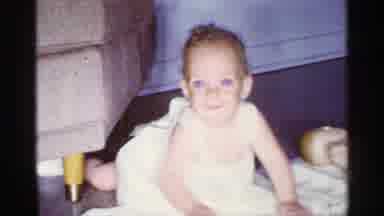 Florida (1959): Baby Wearing White Overfills Plays On White Blanket On Wooden Flo