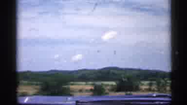 Indiana (1959): Small Mountains Covered In Green Trees Father On Window Of Car