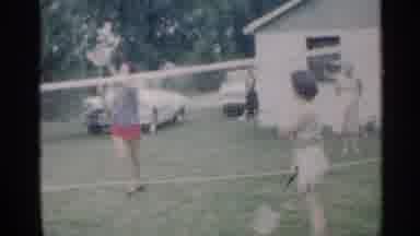 Indiana (1959): Family Plays Badminton In Backyard While Woman Cuts Cake On Picnic