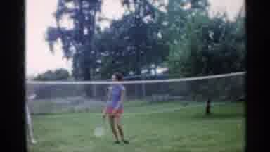 Indiana (1959): People Play Badminton In Yard While Boy Sits