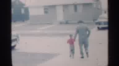 Indiana (1959): Man Wearing Grey Suit Walks With Boy Wearing Red Shirt To Grey Car