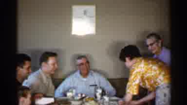 Indiana (1959): Man Wearing Blue Shirt And Glasses Smiles At Woman Wearing Yellow