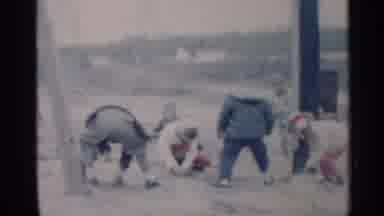 Indiana (1959): Young White Children Hurriedly Dig In Snow Other To One Tempting