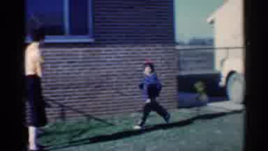 Indiana (1959): Child With Grandparents Runs Towards Woman Who Picks Up Excited