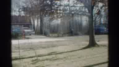 Indiana (1959): House Is Nestled In Tree Surrounded Field With Two Cars Parked