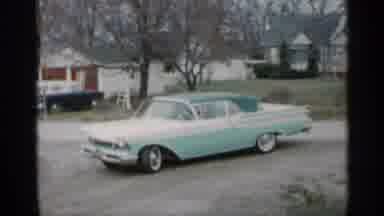 Indiana (1959): Woman And Child Running Round Driveway A Car Is Shown Backing Up