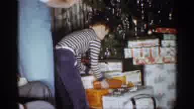 Indiana (1959): Boy Wearing Striped Shirt Picks Up Red Box Father On Tree To