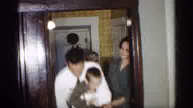Indiana (1959): People Carrying Kid And Putting Him Down Grandma Relaxing On Couch
