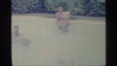 Indiana (1959): Two Men In A Outdo Other Pool With Bushes In Background