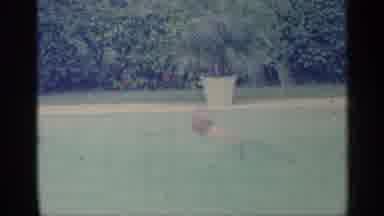 Indiana (1959): Person Swimming In Like To Another Person With Trees In Background