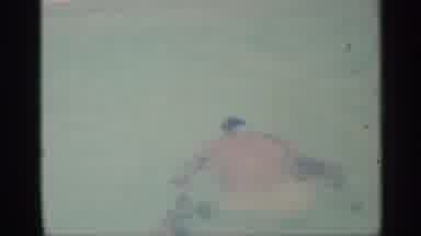 Indiana (1959): In Pool Man In White Swim Trunks Goes Underwater While Man In Tube