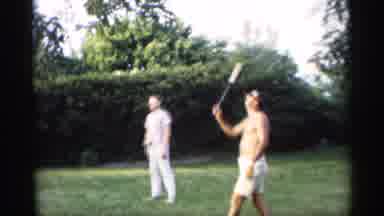 Indiana (1959): Three Adults And One Child Playing Badminton In Yard Sunshine