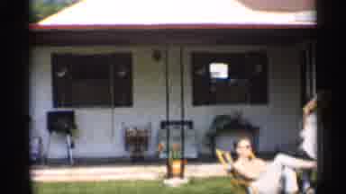Indiana (1959): Man Moving Lounge Chair Out Of Sun In Backyard