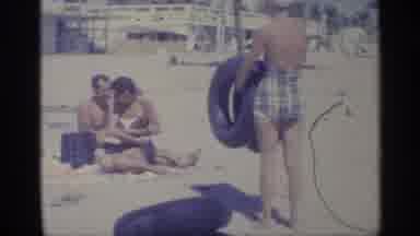 Indiana (1959): Person On Beach With Tires In Her Hand