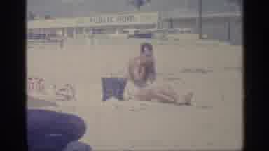 Indiana (1959): Man Sitting On Beach In Father Pool Plies Sunscreen To His Face