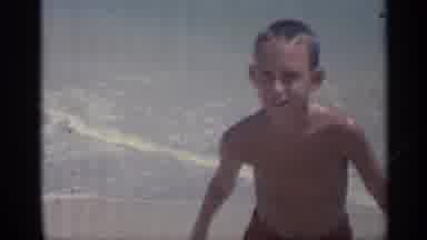 Indiana (1959): Lying In Sn While Child Swims At Sunny Beach