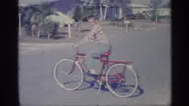Indiana (1959): Boy Wearing Green Ants Sits On Red And Yellow Bicycle On Cleo Day